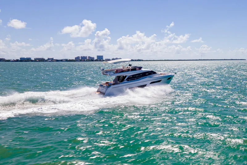 Slide: The Image of 2022 Ferretti Yachts 500 cruising on open water under a clear blue sky. - 8