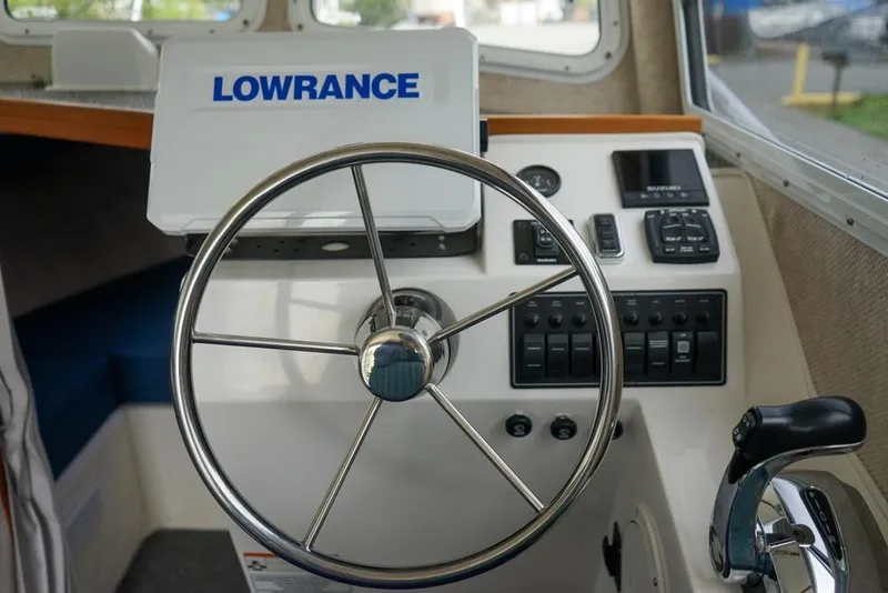 Slide: The Image of Steering console of 2021 Sea Sport Explorer 2400 boat with Lowrance equipment. - 12