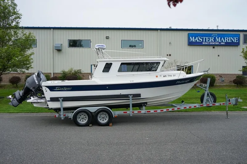 Slide: The Image of 2021 Sea Sport Explorer 2400 boat on trailer outside Master Marine Boat Center. - 2