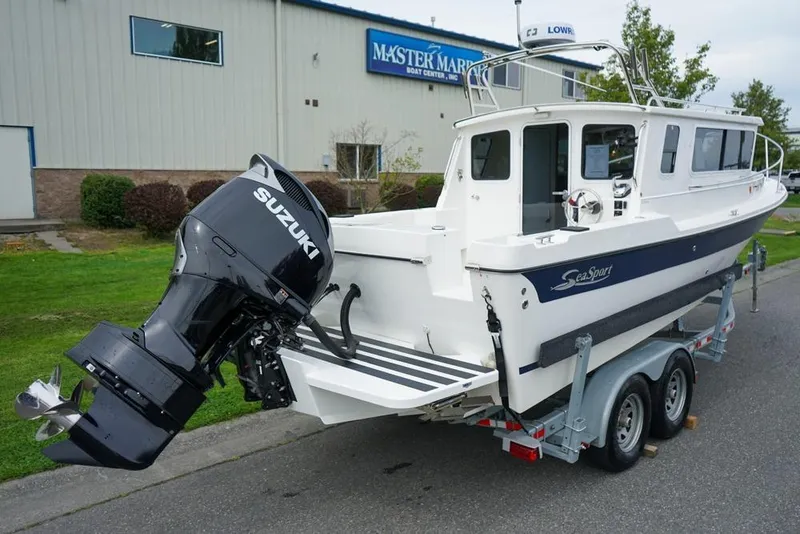Slide: The Image of 2021 Sea Sport Explorer 2400 boat with Suzuki outboard motor on trailer. - 4
