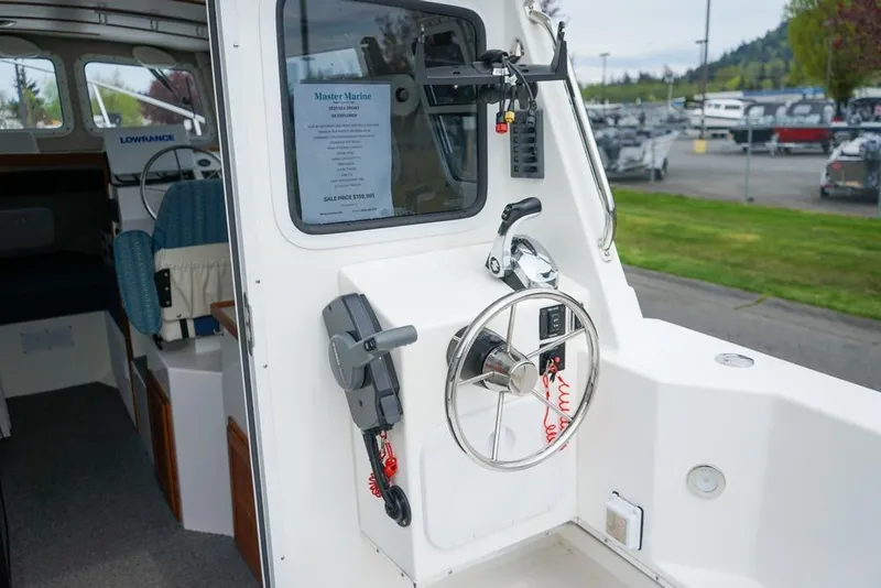 Slide: The Image of Interior view of 2021 Sea Sport Explorer 2400 boat cockpit with steering wheel and controls. - 7