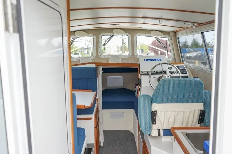Slide: The Image of Interior of 2021 Sea Sport Explorer 2400 boat with seating and navigation equipment. - 8