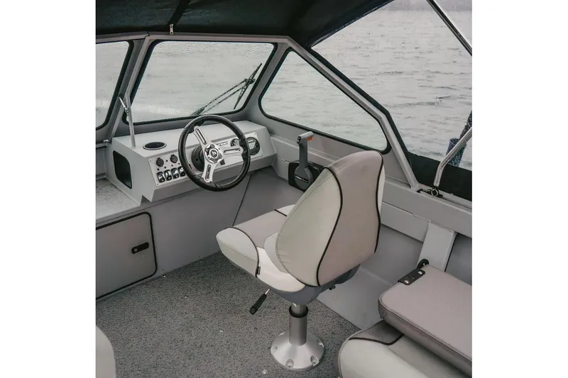 Slide: The Image of Manufacturer Provided Image: Interior of 2026 KingFisher 16 Falcon boat with steering wheel and seat. - 2