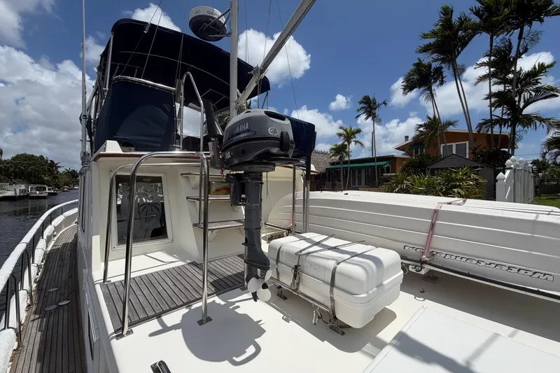 Slide: The Image of 1991 Grand Banks 46 Classic yacht with Yamaha motor, docked near palm trees. - 11
