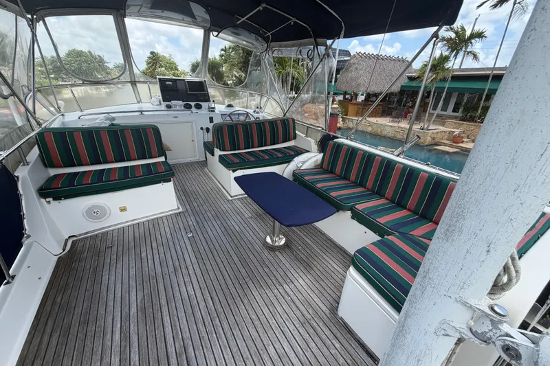 Slide: The Image of Spacious deck of 1991 Grand Banks 46 Classic yacht with striped seating and wooden flooring. - 12