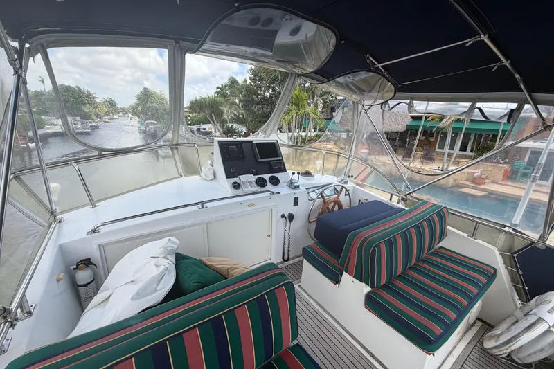 Slide: The Image of Cockpit of 1991 Grand Banks 46 Classic yacht with striped seating and navigation equipment. - 13