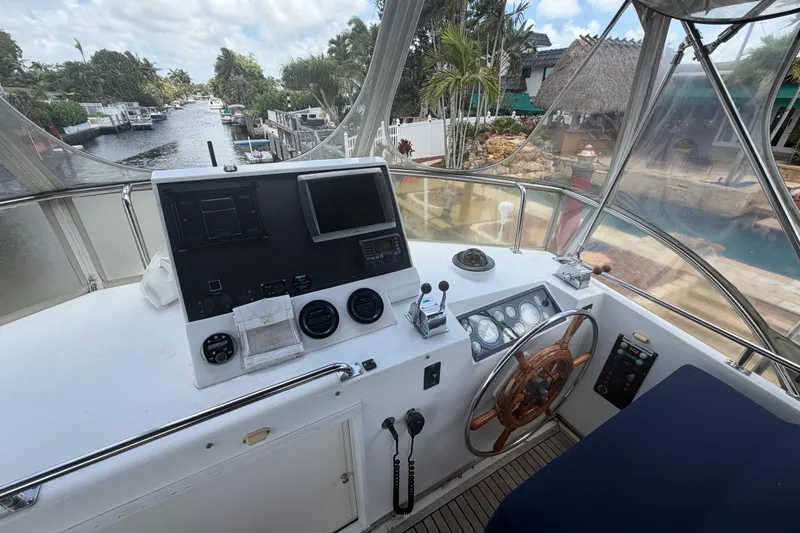 Slide: The Image of Helm of 1991 Grand Banks 46 Classic yacht with navigational instruments and steering wheel. - 14