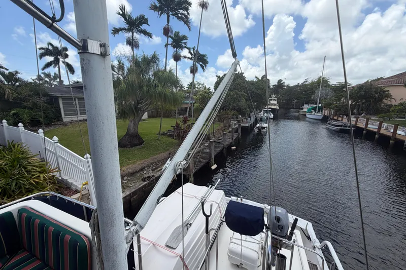 Slide: The Image of Grand Banks 46 Classic yacht docked by a canal with palm trees, 1991 model. - 16