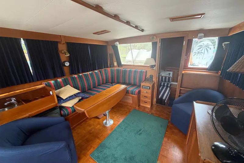 Slide: The Image of Interior of 1991 Grand Banks 46 Classic yacht with striped seating and wooden furnishings. - 17