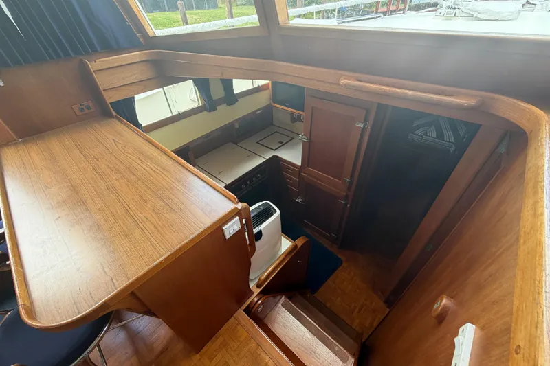 Slide: The Image of Interior view of 1991 Grand Banks 46 Classic yacht, featuring wooden cabinetry and compact kitchen area. - 18