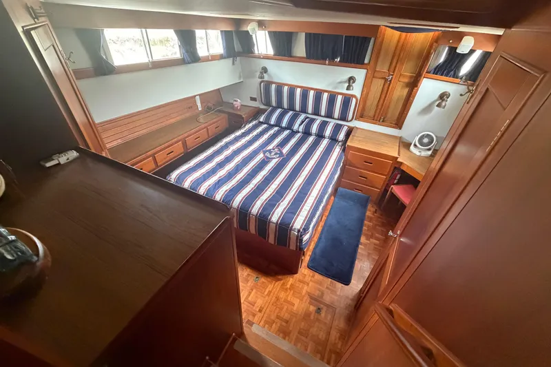 Slide: The Image of Luxurious cabin interior of 1991 Grand Banks 46 Classic yacht with striped bedding. - 19