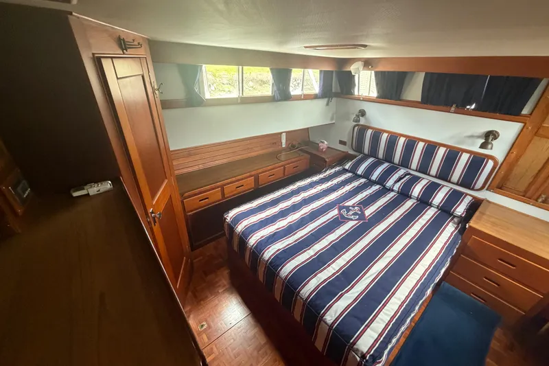 Slide: The Image of Cabin interior of 1991 Grand Banks 46 Classic with striped bedding and wooden furnishings. - 20