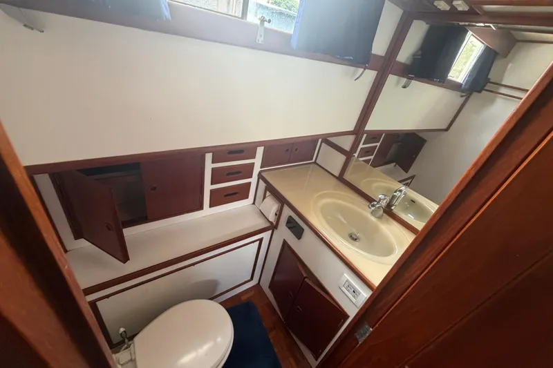 Slide: The Image of Bathroom interior of 1991 Grand Banks 46 Classic yacht, featuring sink and storage cabinets. - 22