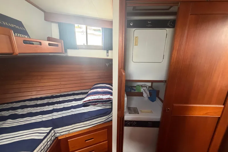 Slide: The Image of Cozy cabin interior of 1991 Grand Banks 46 Classic with striped bedding and laundry area. - 27