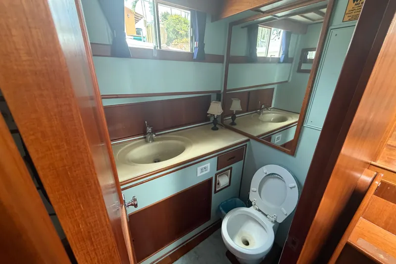 Slide: The Image of Bathroom interior of 1991 Grand Banks 46 Classic yacht, featuring wood accents and dual sinks. - 28