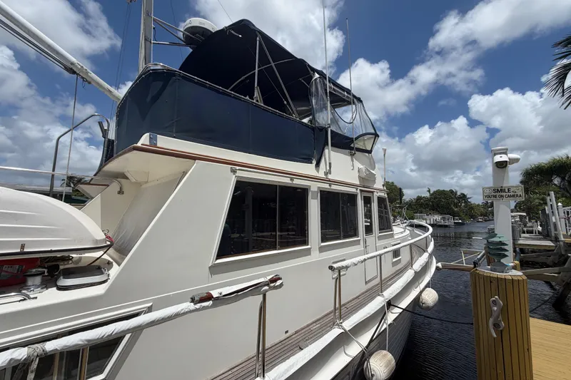 Slide: The Image of 1991 Grand Banks 46 Classic yacht docked under a partly cloudy sky. - 3