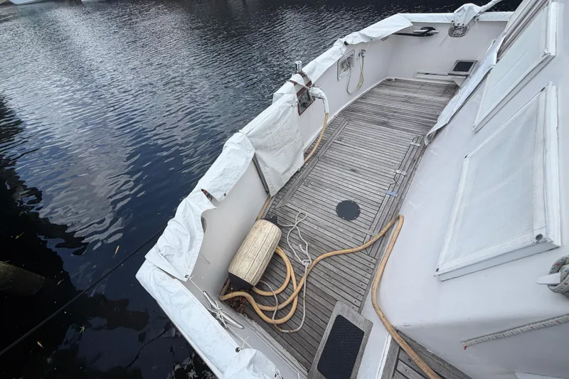 Slide: The Image of Deck of 1991 Grand Banks 46 Classic yacht with wooden flooring and ropes. - 32