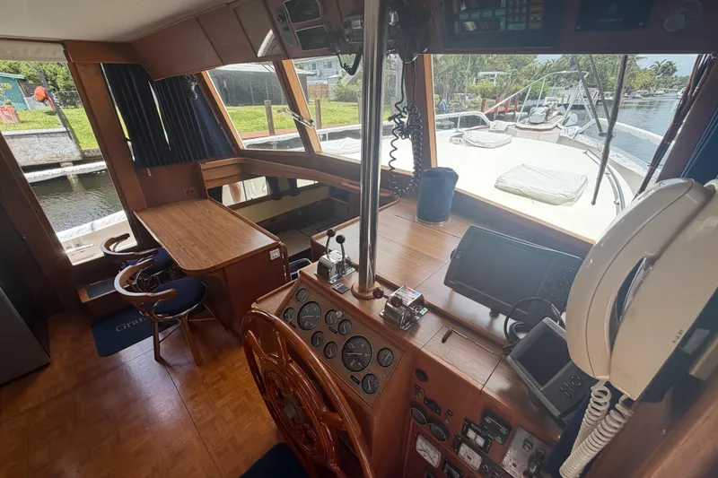 Slide: The Image of Interior of 1991 Grand Banks 46 Classic yacht with helm, navigation equipment, and seating area. - 40