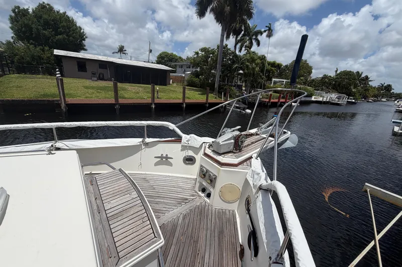 Slide: The Image of Bow view of 1991 Grand Banks 46 Classic yacht docked by a canal. - 5