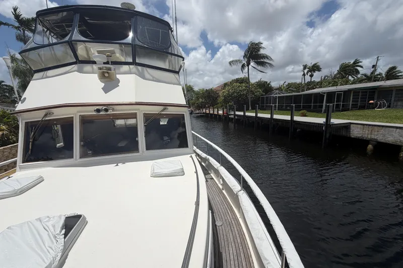 Slide: The Image of Grand Banks 46 Classic yacht docked by a canal, 1991 model, under a partly cloudy sky. - 6