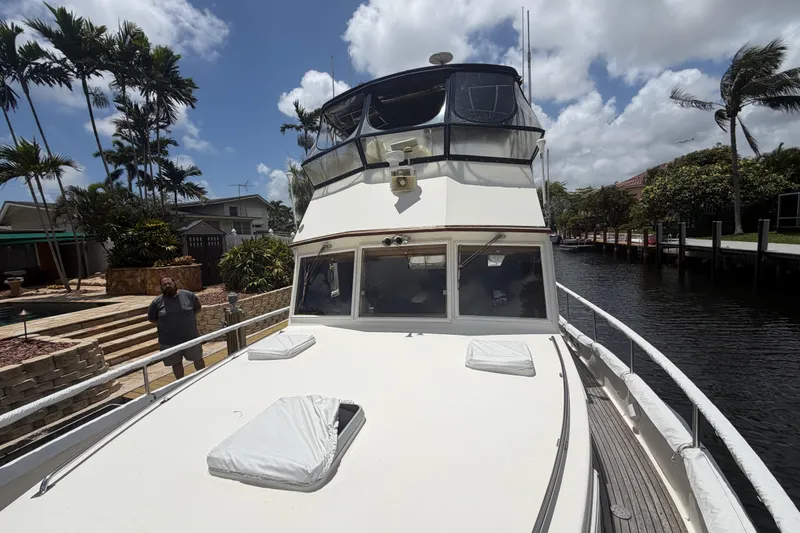 Slide: The Image of 1991 Grand Banks 46 Classic yacht docked by a canal under a partly cloudy sky. - 7