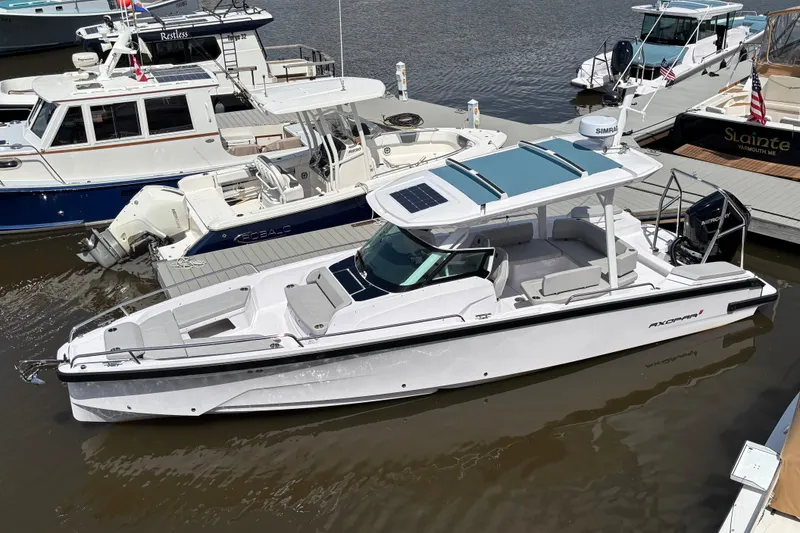 The Image of 2025 Axopar 29 Sun-Top boat docked at marina, featuring sleek design and spacious seating. - 0