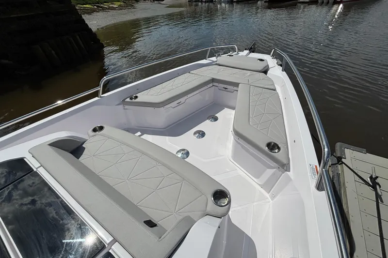 Slide: The Image of 2025 Axopar 29 Sun-Top boat with spacious seating and sleek design on the water. - 10