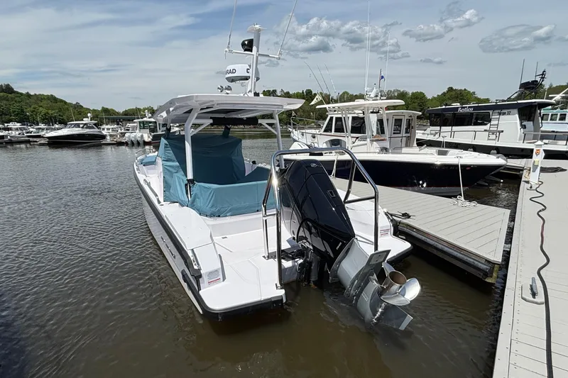 Slide: The Image of 2025 Axopar 29 Sun-Top boat docked at marina, rear view. - 18