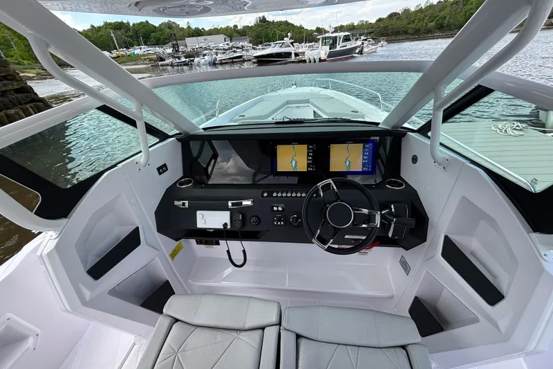 Slide: The Image of Interior view of 2025 Axopar 29 Sun-Top boat cockpit with modern navigation system. - 20