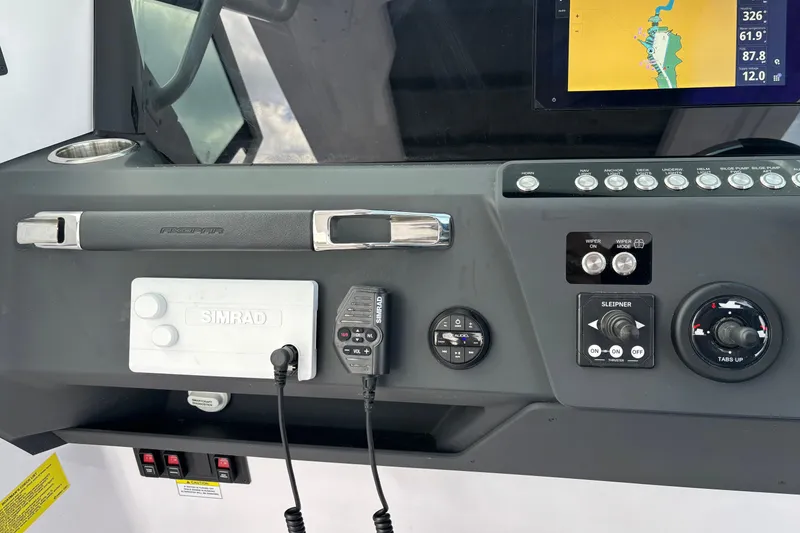 Slide: The Image of Control panel of 2025 Axopar 29 Sun-Top boat with navigation and communication equipment. - 23