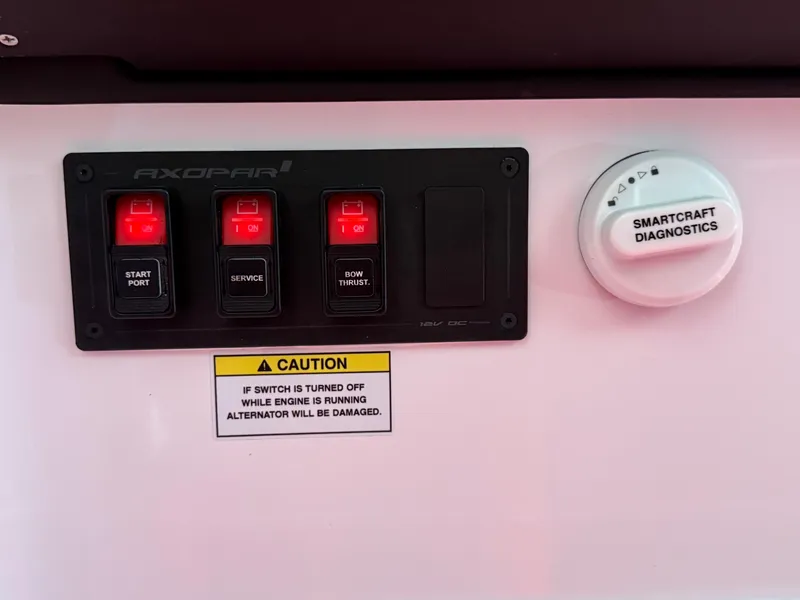 Slide: The Image of Control panel of 2025 Axopar 29 Sun Top with SmartCraft diagnostics and caution label. - 26