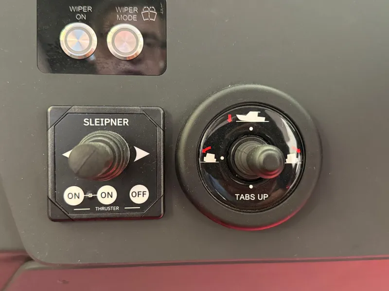 Slide: The Image of Control panel of 2025 Axopar 29 Sun Top with thruster and trim tab switches. - 27