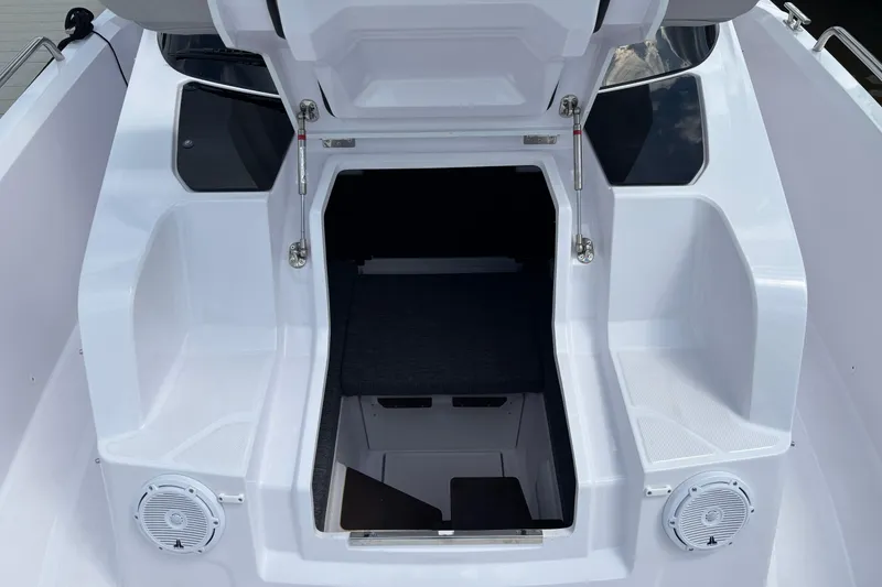 Slide: The Image of 2025 Axopar 29 Sun-Top boat interior with open hatch and seating area. - 28