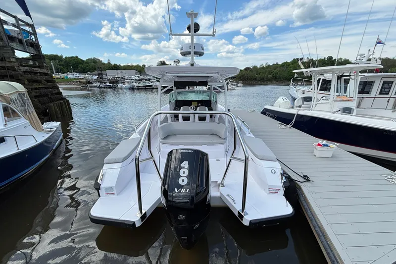 Slide: The Image of 2025 Axopar 29 Sun-Top boat docked, featuring a powerful Mercury 400 V10 engine. - 3