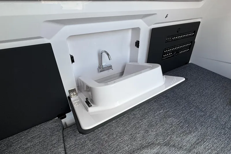 Slide: The Image of 2025 Axopar 29 Sun-Top interior sink and control panel detail. - 32