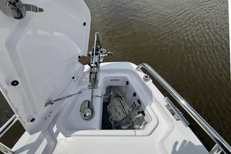 Slide: The Image of Open anchor compartment on 2025 Axopar 29 Sun-Top boat, showing anchor and rope storage. - 35