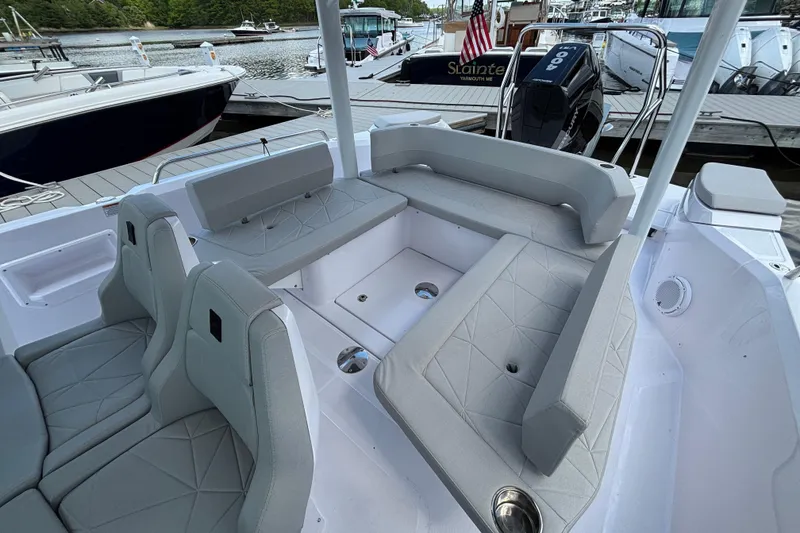 Slide: The Image of 2025 Axopar 29 Sun-Top boat interior with gray seating and modern design. - 6