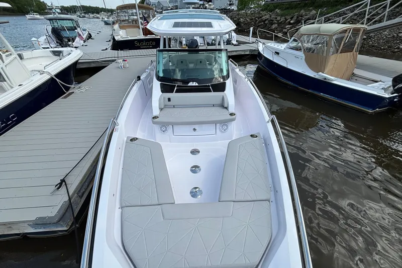 Slide: The Image of 2025 Axopar 29 Sun-Top boat docked, featuring sleek design and spacious seating. - 9