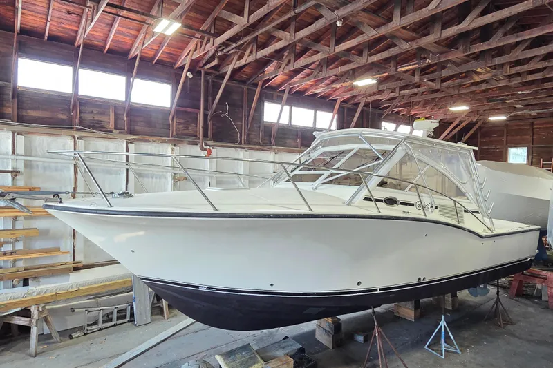 Slide: The Image of 2004 Carolina Classic 35 boat in a wooden boathouse, showcasing sleek design and sturdy construction. - 1