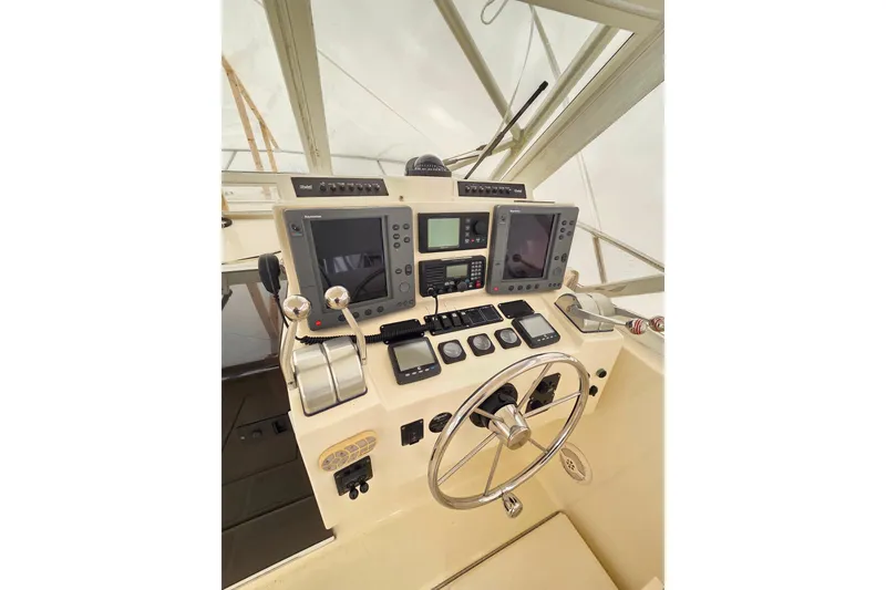 Slide: The Image of Helm of 2004 Carolina Classic 35 boat with navigation equipment and steering wheel. - 12