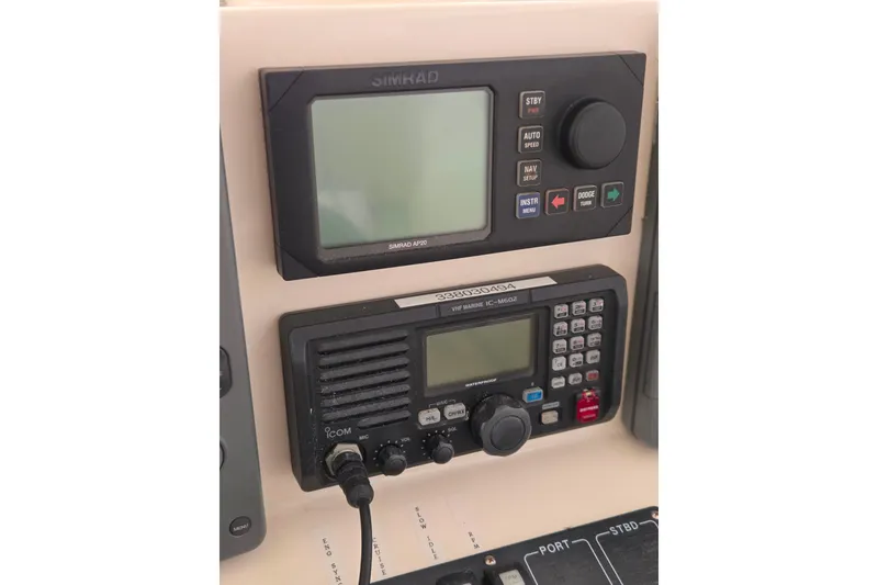 Slide: The Image of Simrad AP20 and Icom VHF Marine IC-M602 on 2004 Carolina Classic 35 boat dashboard. - 13