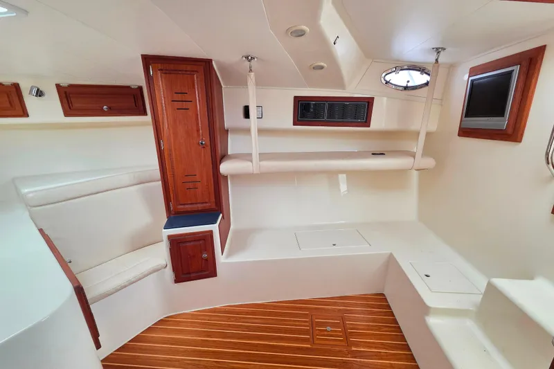 Slide: The Image of Interior of a 2004 Carolina Classic 35 boat with wood accents and seating. - 16