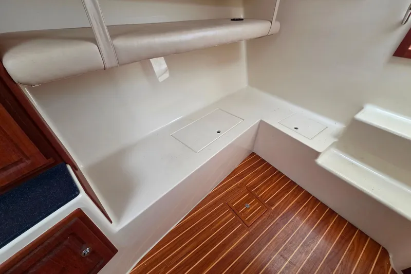 Slide: The Image of Interior of 2004 Carolina Classic 35 boat with wooden flooring and storage compartments. - 17