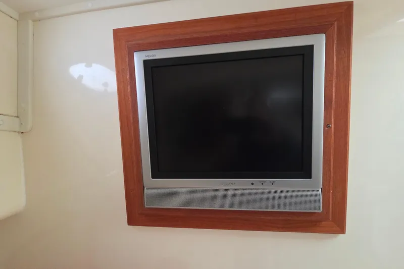 Slide: The Image of Built-in TV on a 2004 Carolina Classic 35 boat, framed in wood. - 18