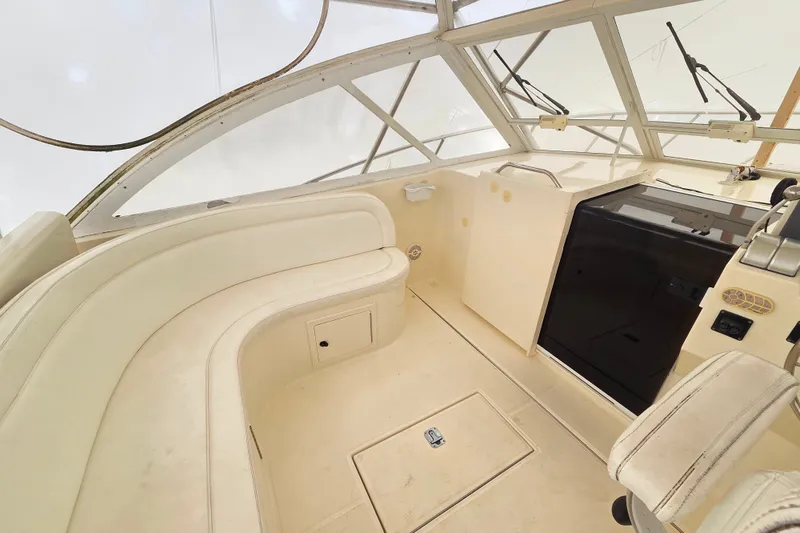 Slide: The Image of 2004 Carolina Classic 35 boat interior with seating and helm, featuring a clean, spacious design. - 21