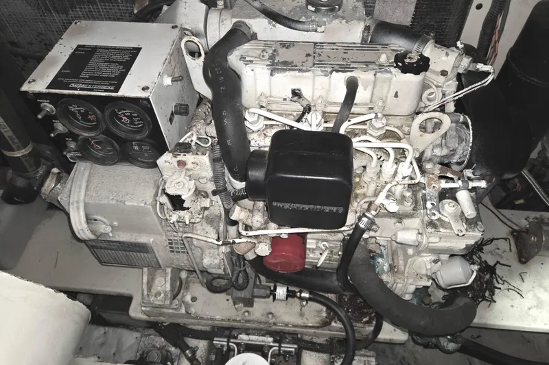 Slide: The Image of Engine compartment of a 2004 Carolina Classic 35 boat, showcasing mechanical components and gauges. - 27