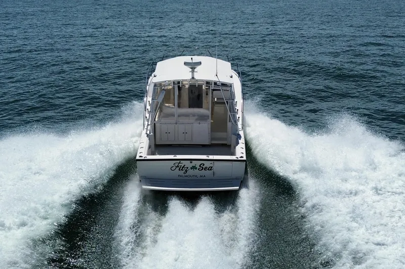 Slide: The Image of 2004 Carolina Classic 35 boat cruising on open water, leaving a wake behind. - 29