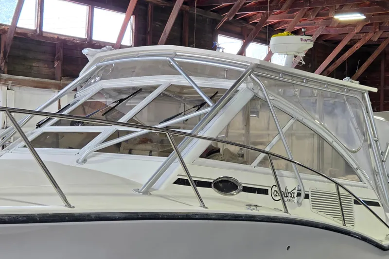 Slide: The Image of 2004 Carolina Classic 35 boat in a wooden boathouse, showcasing its sleek design. - 3