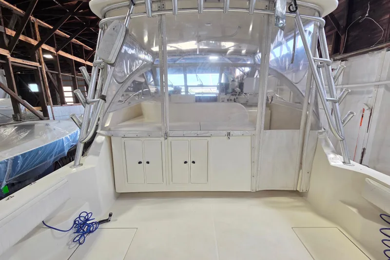 Slide: The Image of 2004 Carolina Classic 35 boat interior with clear enclosure and storage cabinets. - 5