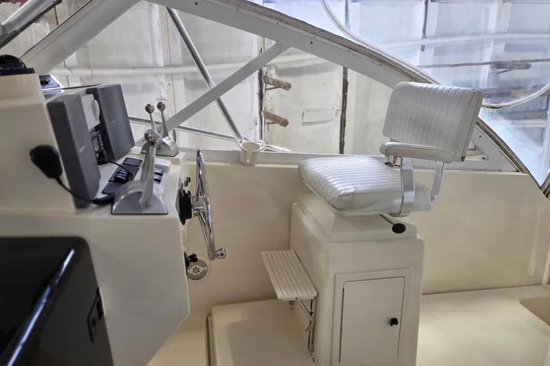 Slide: The Image of Helm station of 2004 Carolina Classic 35 boat with captain's chair and controls. - 8